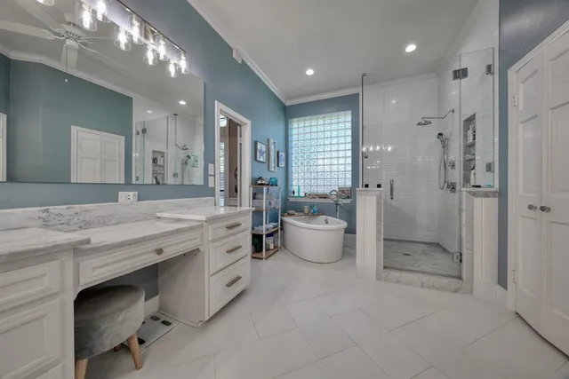 a spacious bathroom with a granite countertop sink a toilet a shower and a mirror