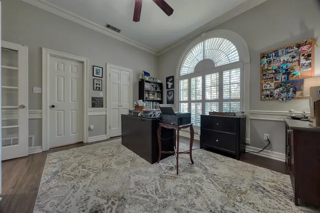 a view of a livingroom with workspace and a window