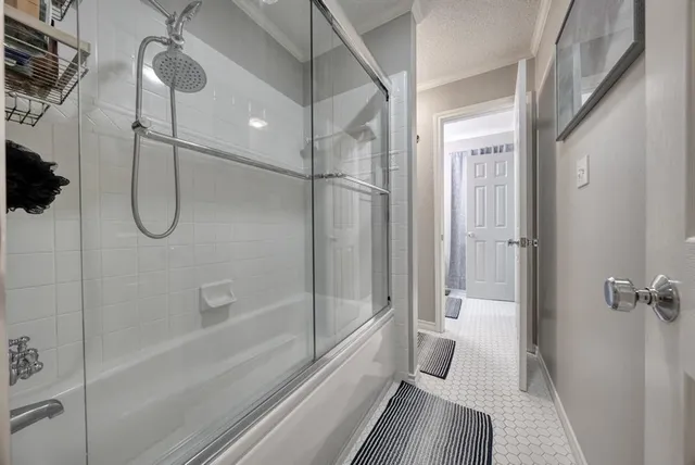 a bathroom with a glass shower door
