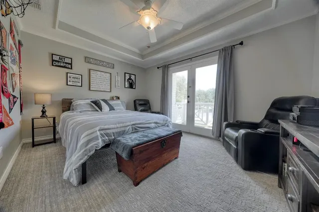 a bedroom with a bed and a chandelier