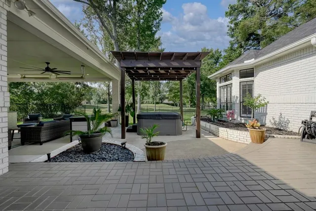 a view of a patio with a table and chairs and potted plants