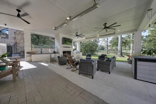 a living room with lots of furniture and a large window