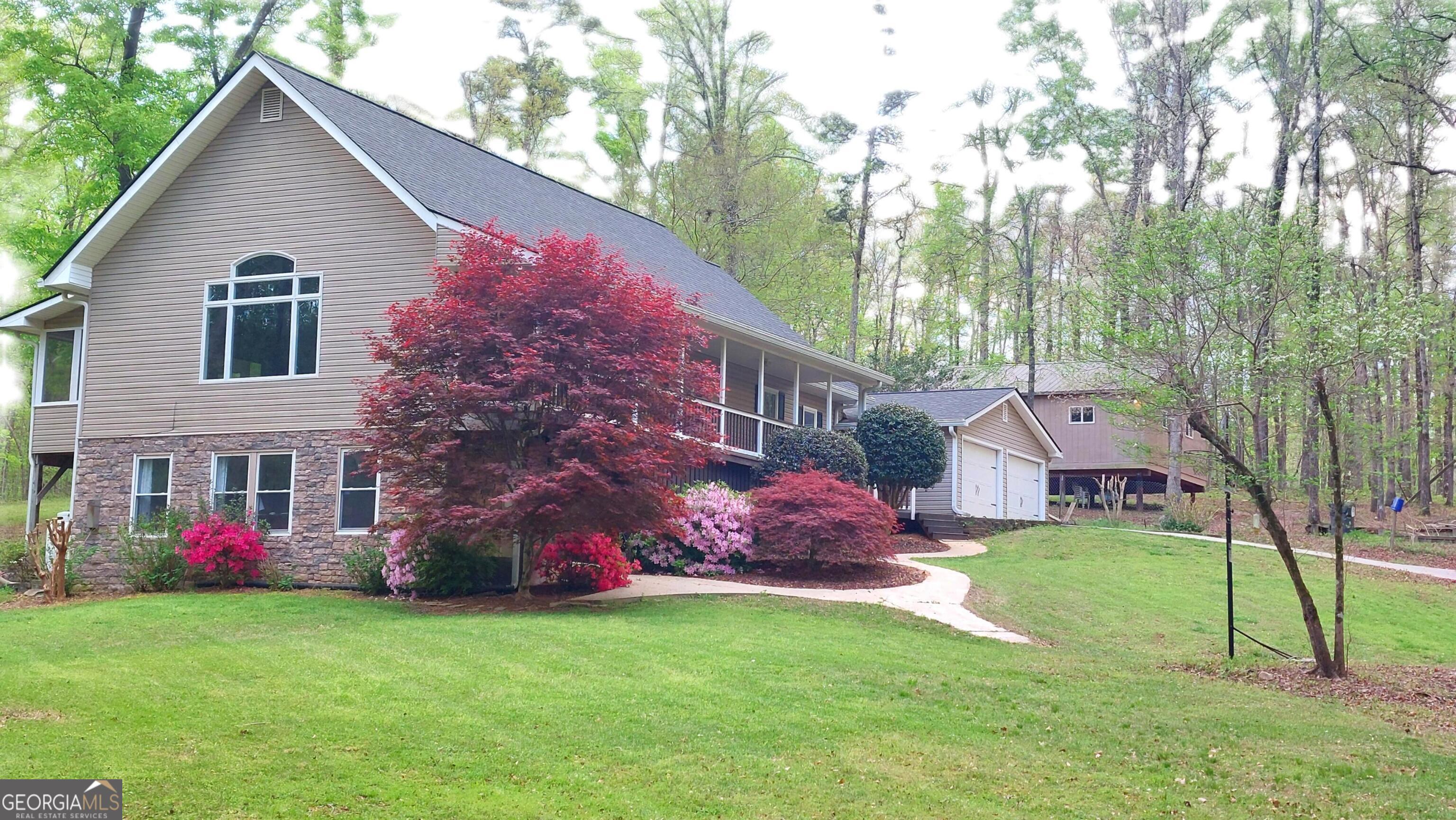 335 Winding Stream Trail Hampton, GA 30228 - Photo 2 of 35 a view of a house with a yard