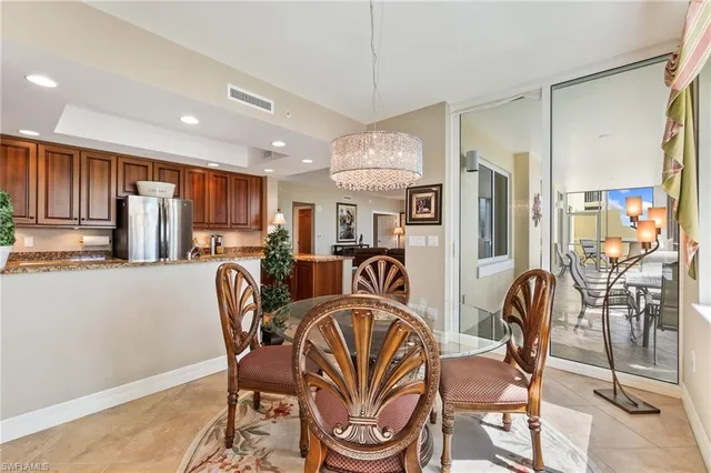 a dining room filled chandelier and wooden floor