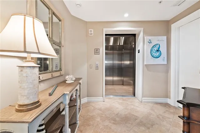 a bathroom with a sink a mirror a lamp and window