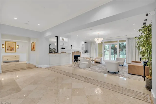 a view of living room filled with furniture and potted plant
