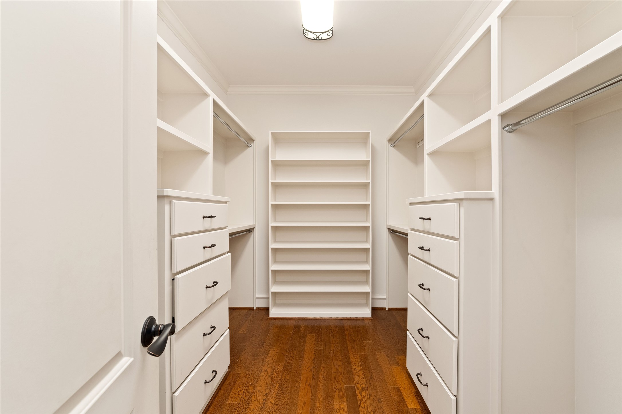 4102 Gramercy Street Houston, TX 77025 - Photo 20 of 35 a room with white cabinets and a wooden floor