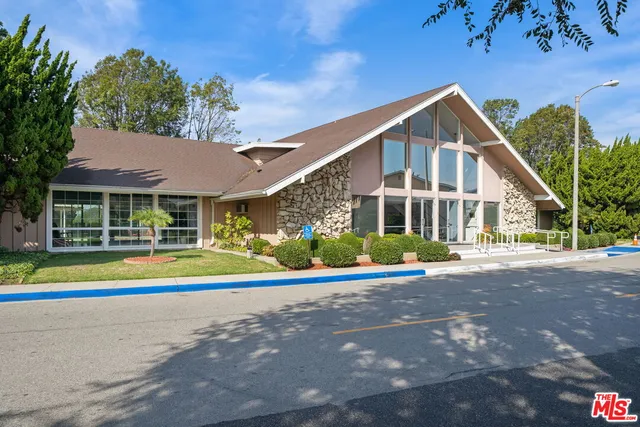 a view of a house with a yard and plants