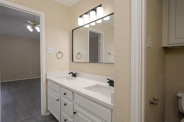 a bathroom with a sink vanity and mirror