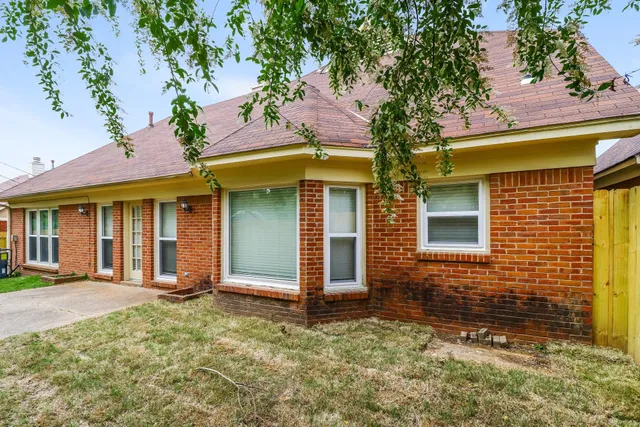 front view of a brick house with a large windows
