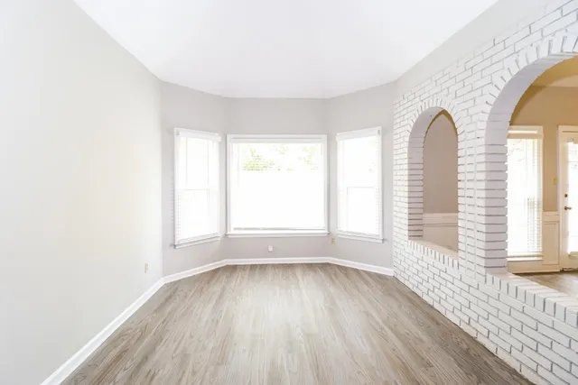 a view of a room with wooden floor and window