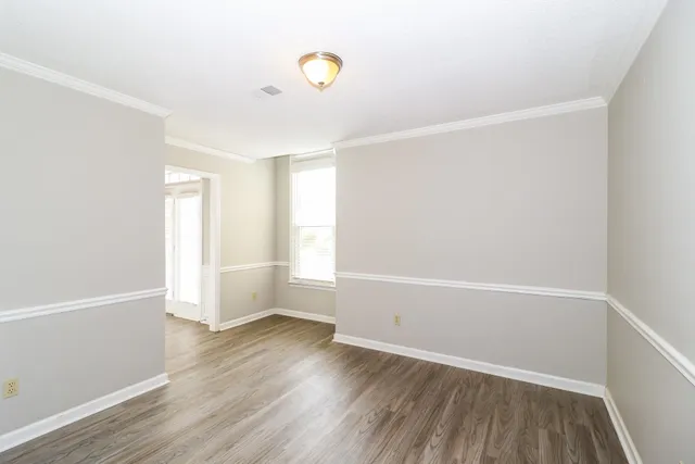 a view of room with window and wooden floor