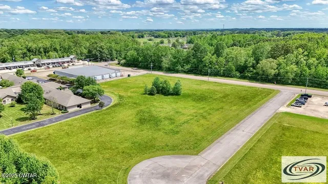 a view of a swimming pool with a yard
