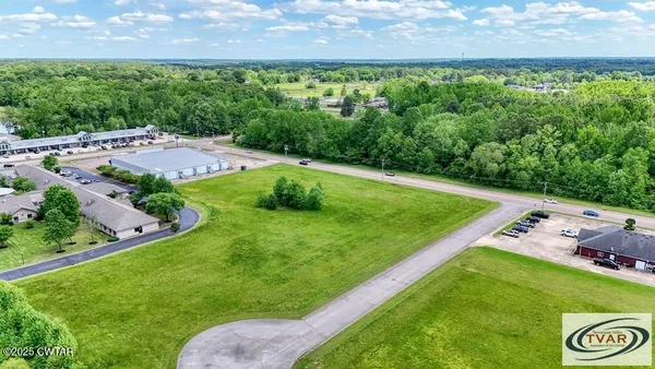 a view of a golf course with parking space