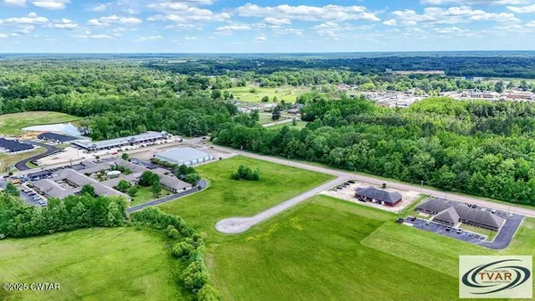 an aerial view of a golf course with chairs
