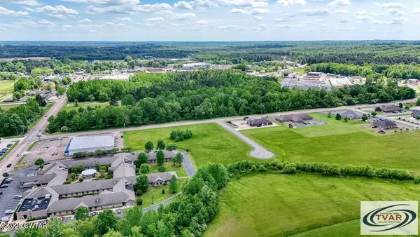 an aerial view of a house with a yard