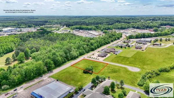 an aerial view of a residential houses with outdoor space