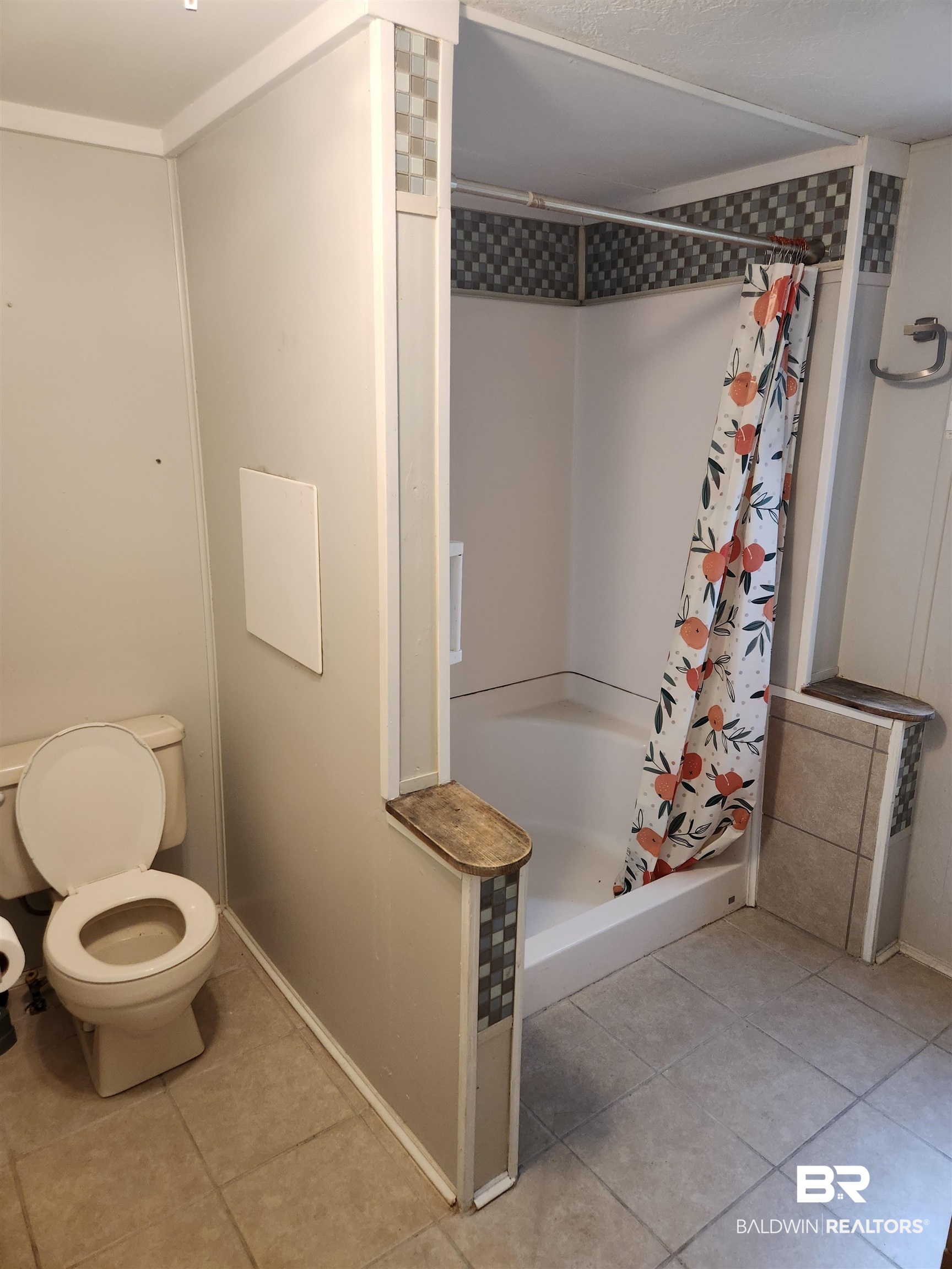 23051 Fritz Lane Foley, AL 36535 - Photo 24 of 26 Bathroom featuring a shower stall with a white base, partial tile surround, and a coordinating tile border