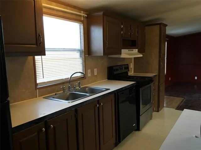 a kitchen with stainless steel appliances granite countertop a stove and a refrigerator