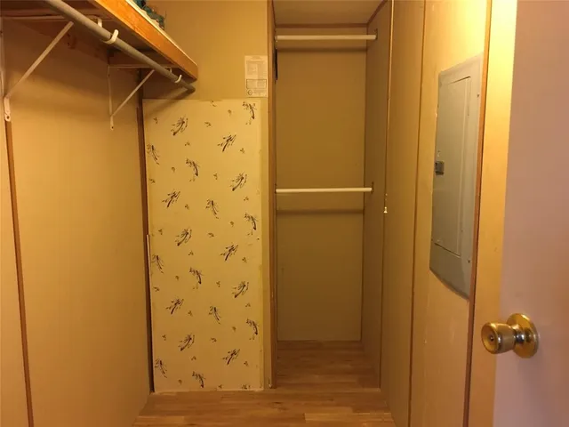 a view of hallway with wooden floor