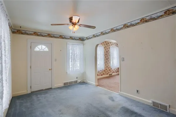 a view of a livingroom with furniture and hardwood floor