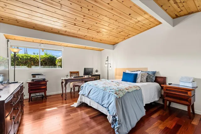 a bedroom with a bed and a desk