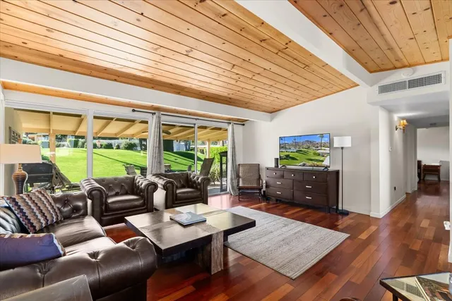 a living room with furniture and a open window