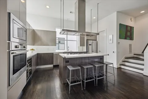 a kitchen with stainless steel appliances a sink stove and cabinets