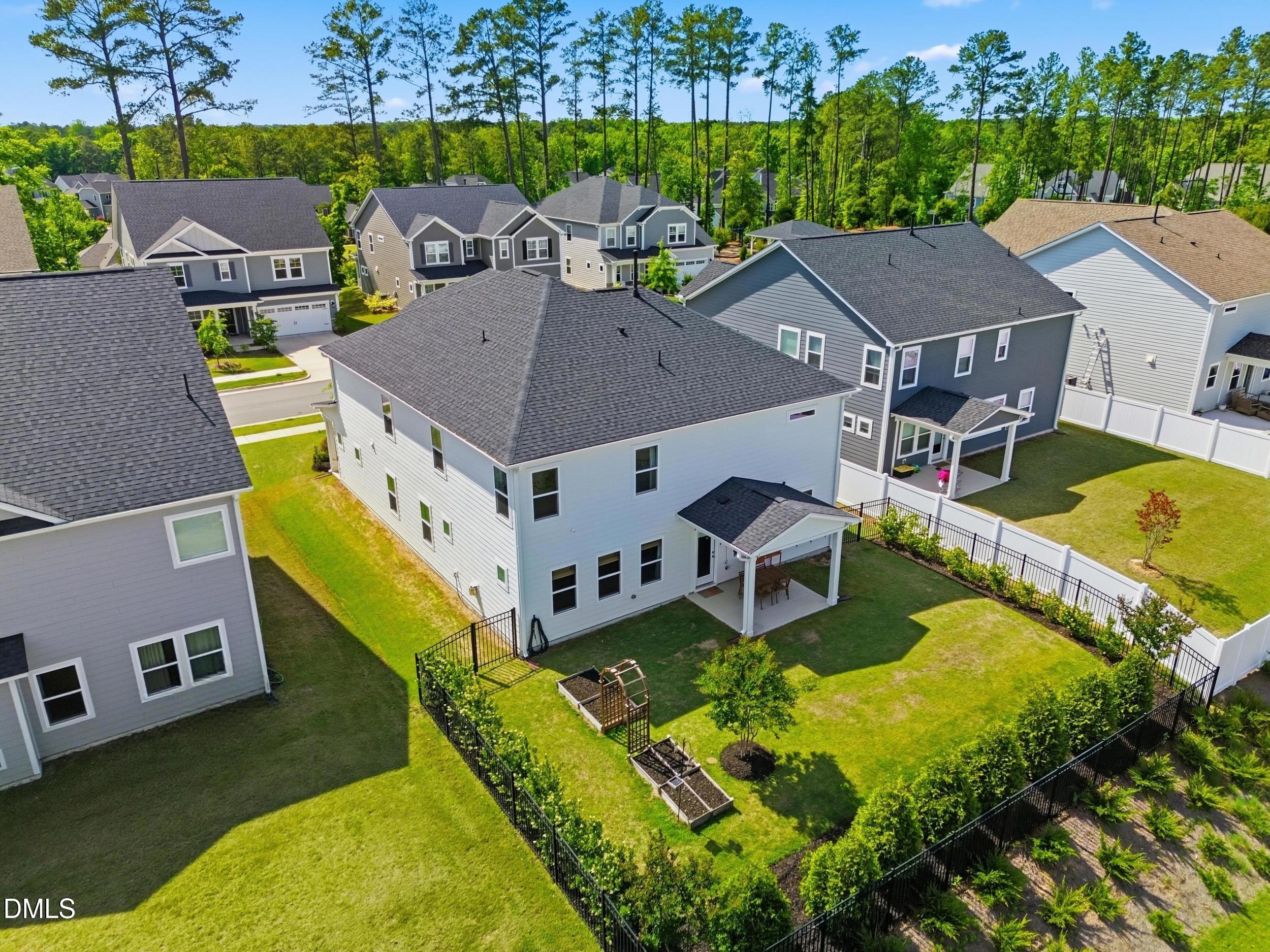 2709 Womble Ridge Drive New Hill, NC 27562 - Photo 60 of 60 an aerial view of a house with swimming pool and large trees