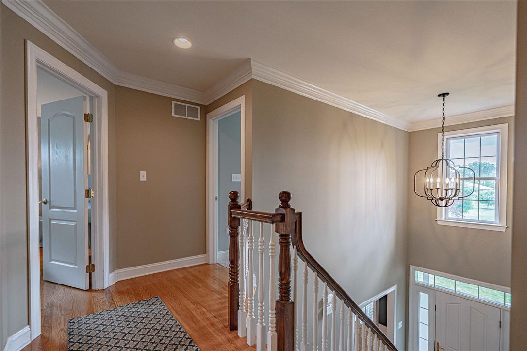 6000 Pond View Terrace Bath, PA 18014 - Photo 33 of 69 Hardwood floors and crisp white trim adorn this inviting upstairs hallway, leading to well-appointed living spaces.