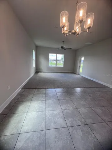 a view of entryway and hall with a chandelier