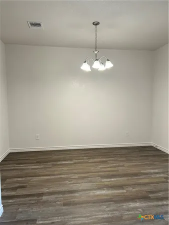 a view of an empty room with a chandelier
