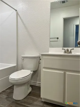 a bathroom with a sink toilet and mirror