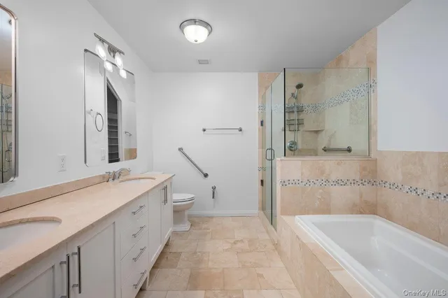 a spacious bathroom with a bathtub sink and mirror