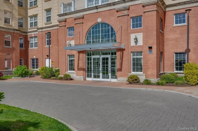 front view of a brick house with a yard