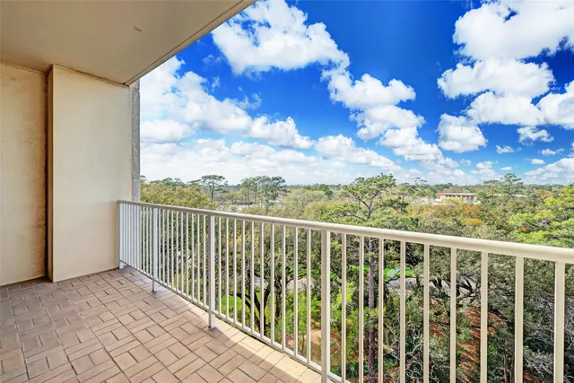 a view of a balcony with wooden floor