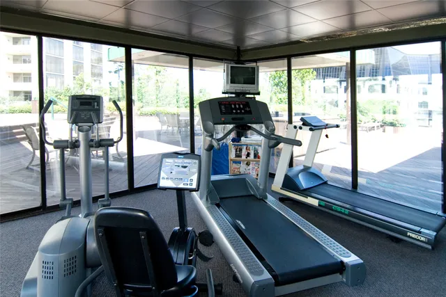 a room with gym equipment and a large window