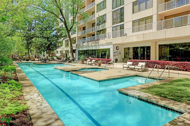 a view of a building with garden and sitting area