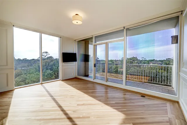 a view of a room with wooden floor and city view
