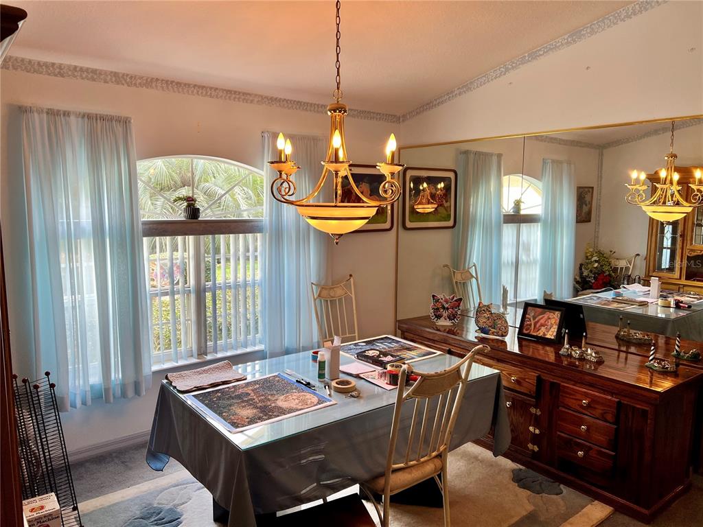 1995 East Newhaven Street Inverness, FL 34453 - Photo 21 of 48 a dining room with wooden floor and chandelier
