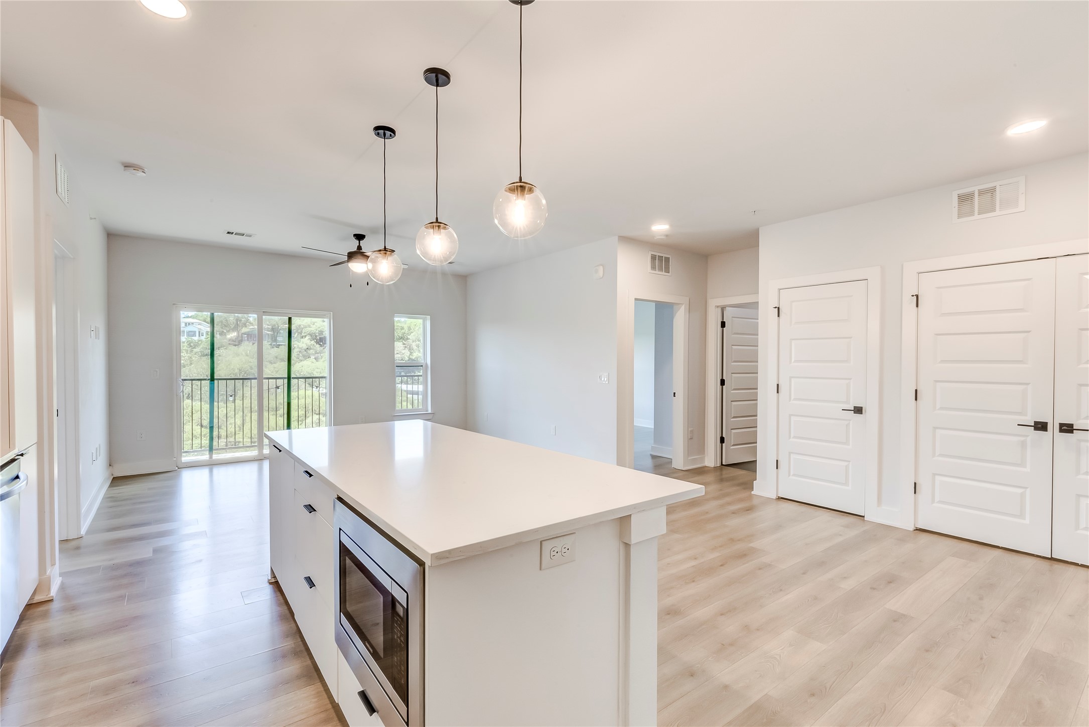 2500 Longview Street, Unit 402 Austin, TX 78705 - Photo 11 of 27 a large kitchen with kitchen island a stove a sink and a chandelier