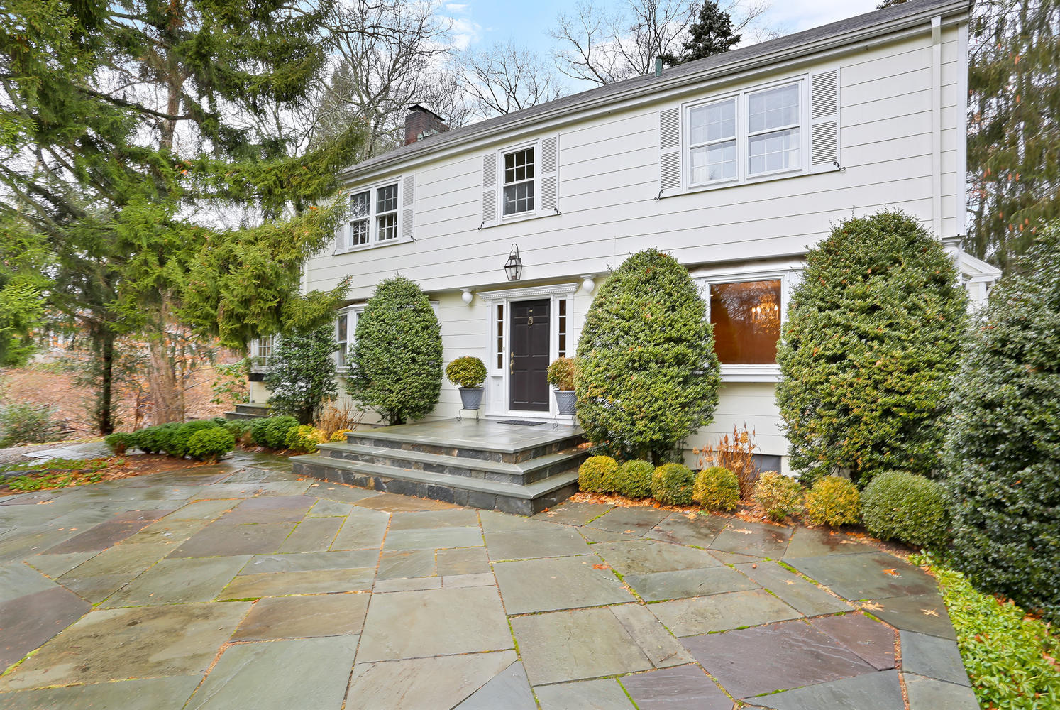65 Nursery Road New Canaan, CT 06840 - Photo 1 of 37 a front view of a house with garden