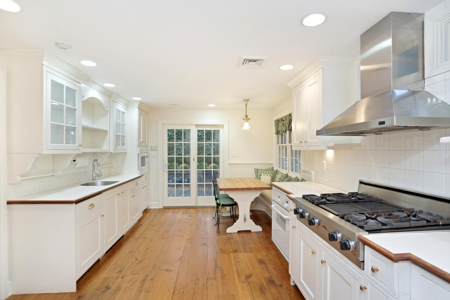 65 Nursery Road New Canaan, CT 06840 - Photo 13 of 37 a large kitchen with stainless steel appliances granite countertop a lot of counter space and a wooden floors