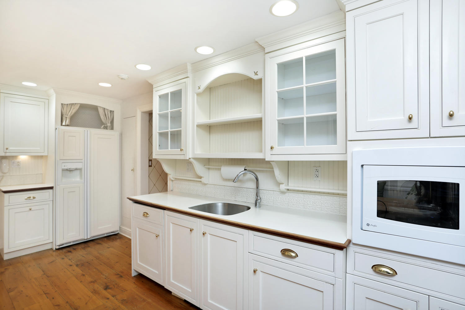 65 Nursery Road New Canaan, CT 06840 - Photo 15 of 37 a kitchen with a sink cabinets and wooden floor
