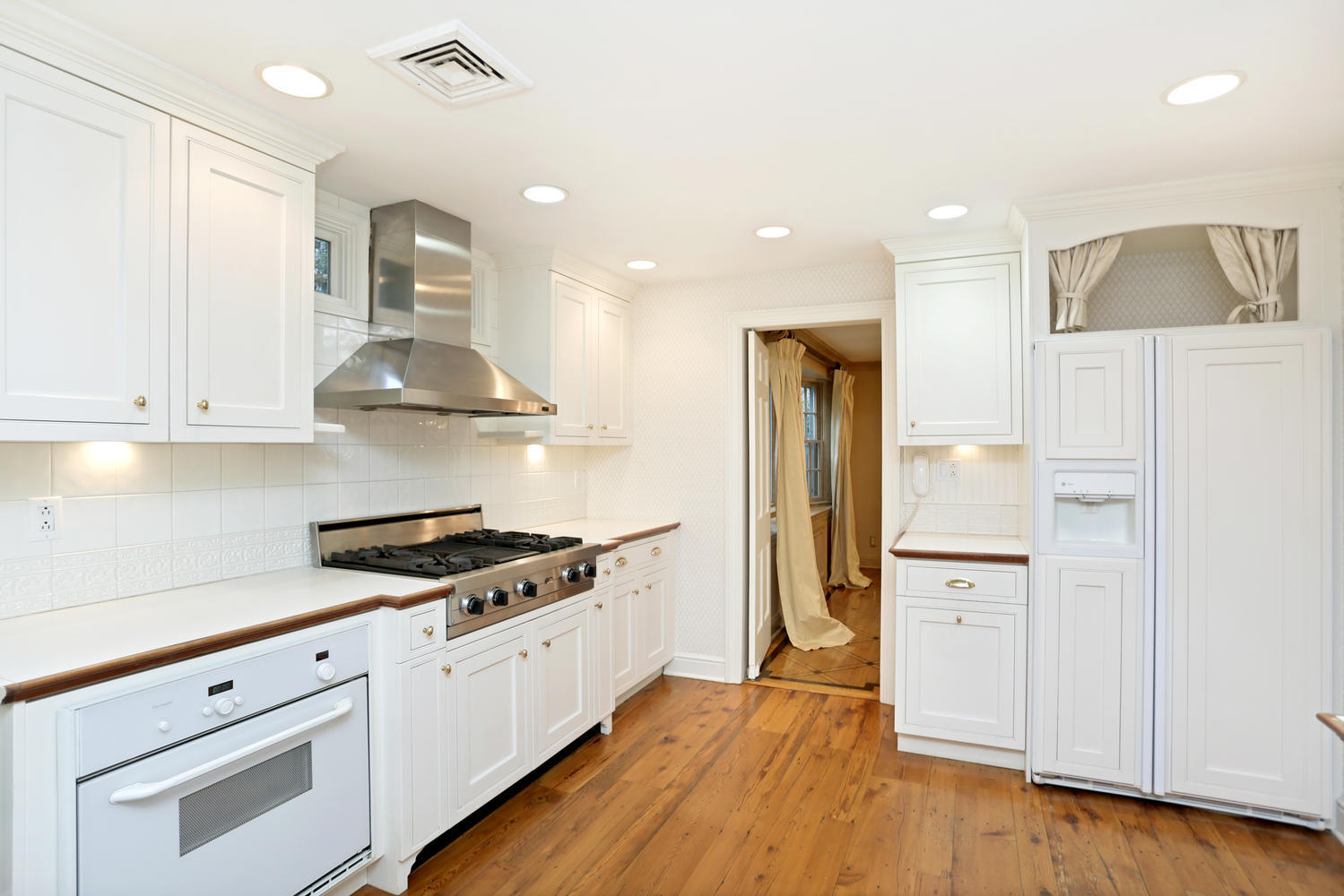 65 Nursery Road New Canaan, CT 06840 - Photo 16 of 37 a kitchen with stainless steel appliances a refrigerator stove and white cabinets