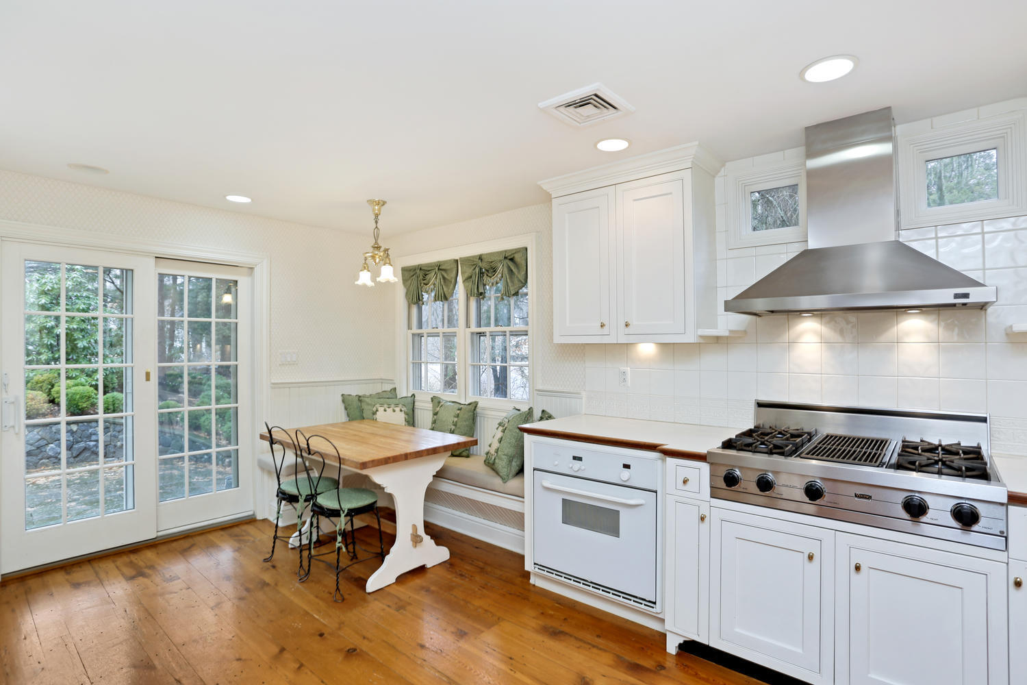 65 Nursery Road New Canaan, CT 06840 - Photo 17 of 37 a kitchen with a stove a table and chairs in it