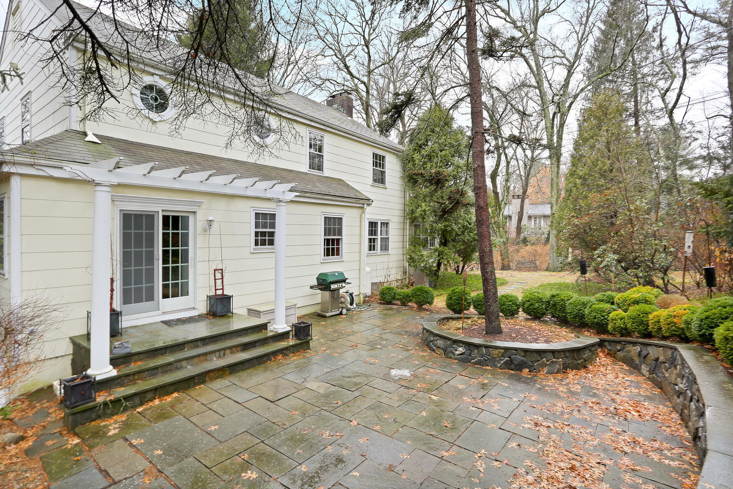 65 Nursery Road New Canaan, CT 06840 - Photo 27 of 37 a front view of a house with a garden
