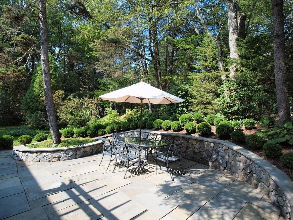 65 Nursery Road New Canaan, CT 06840 - Photo 29 of 37 a view of a table and chairs under an umbrella in the patio