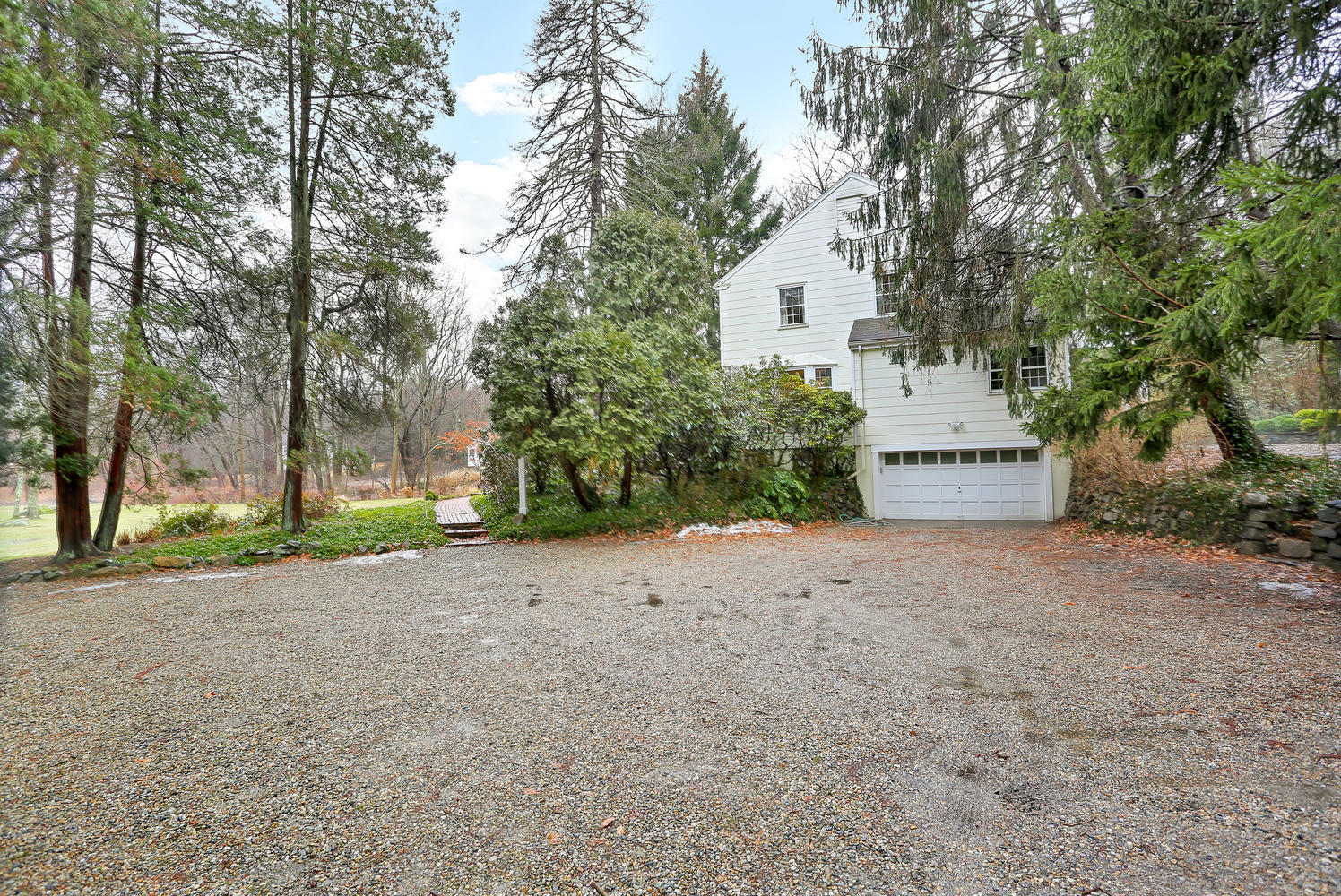 65 Nursery Road New Canaan, CT 06840 - Photo 33 of 37 a view of a house with a yard and garage