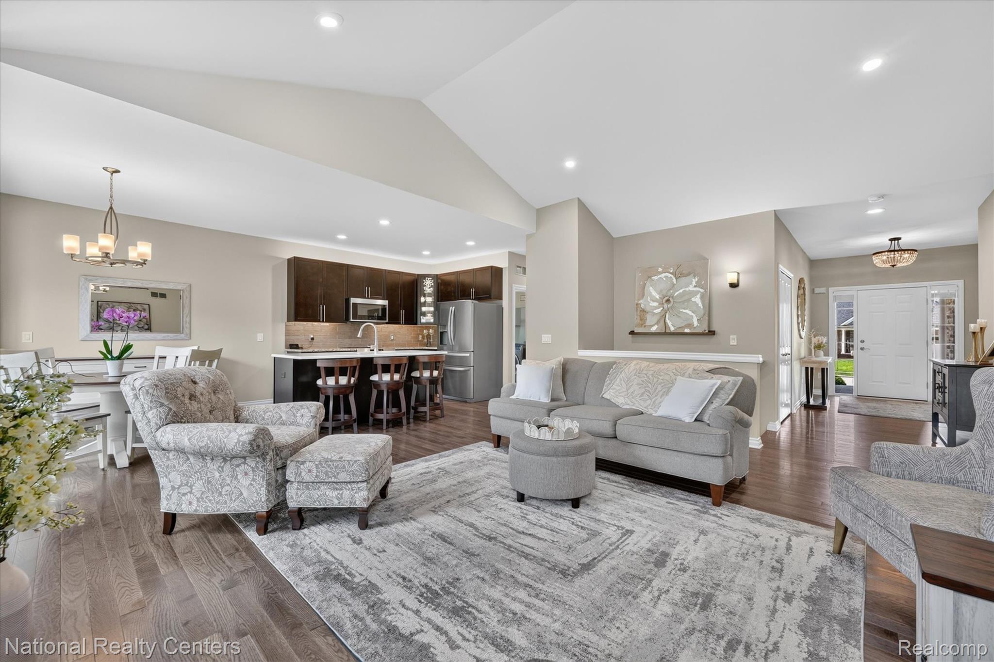 740 North Mill Street South Lyon, MI 48178 - Photo 12 of 56 Open-concept living area featuring vaulted ceilings and recessed lighting